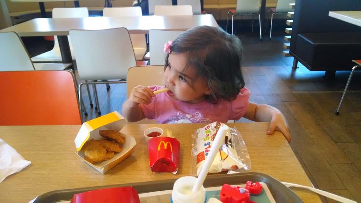 toddler eating a happy meal