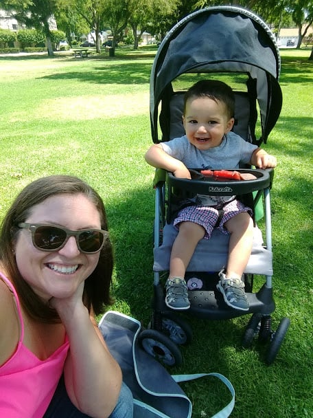 Salty momma Jaymi sitting with her son. Toddler is in a stroller in a Park setting.