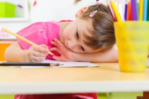 sad little girl drawing a picture for her dying grandparent