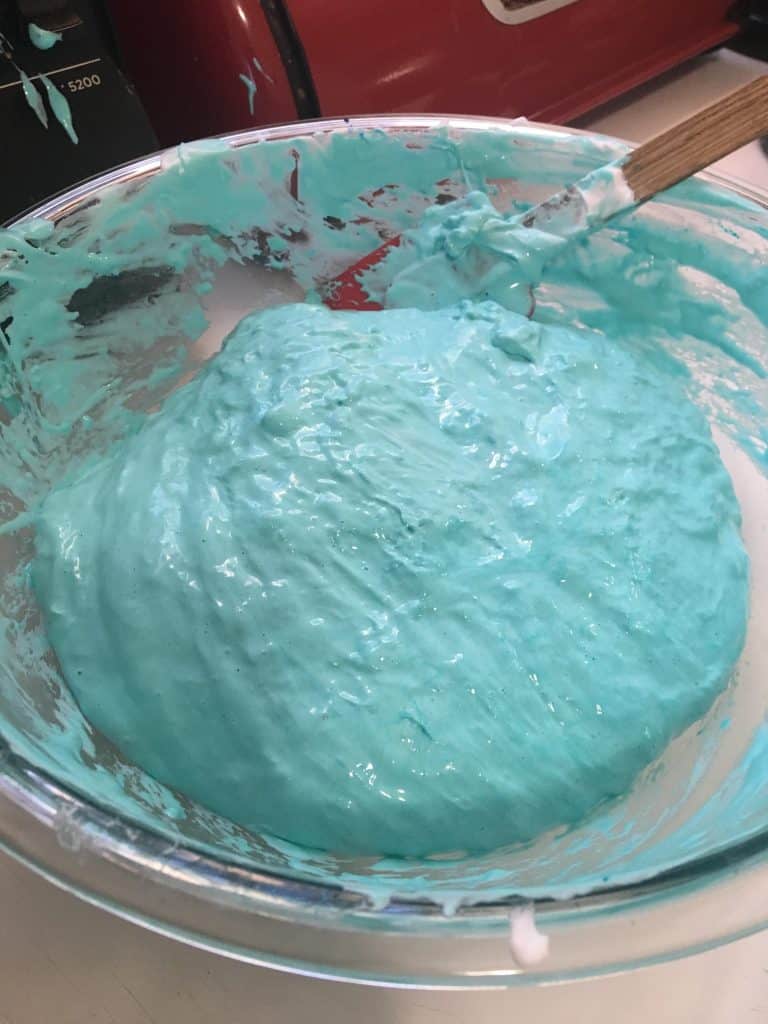 Glue mixture and borax mixture in a metal bowl.