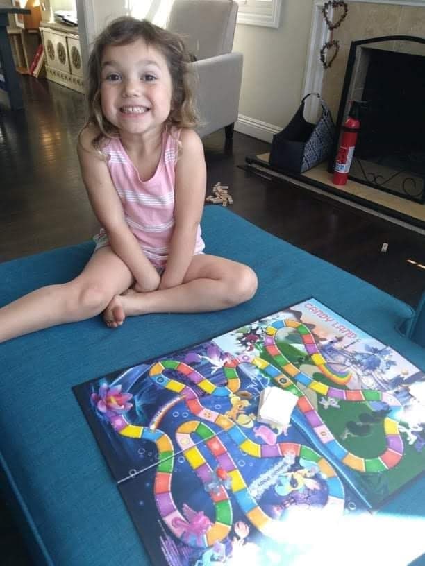 little girl playing candyland