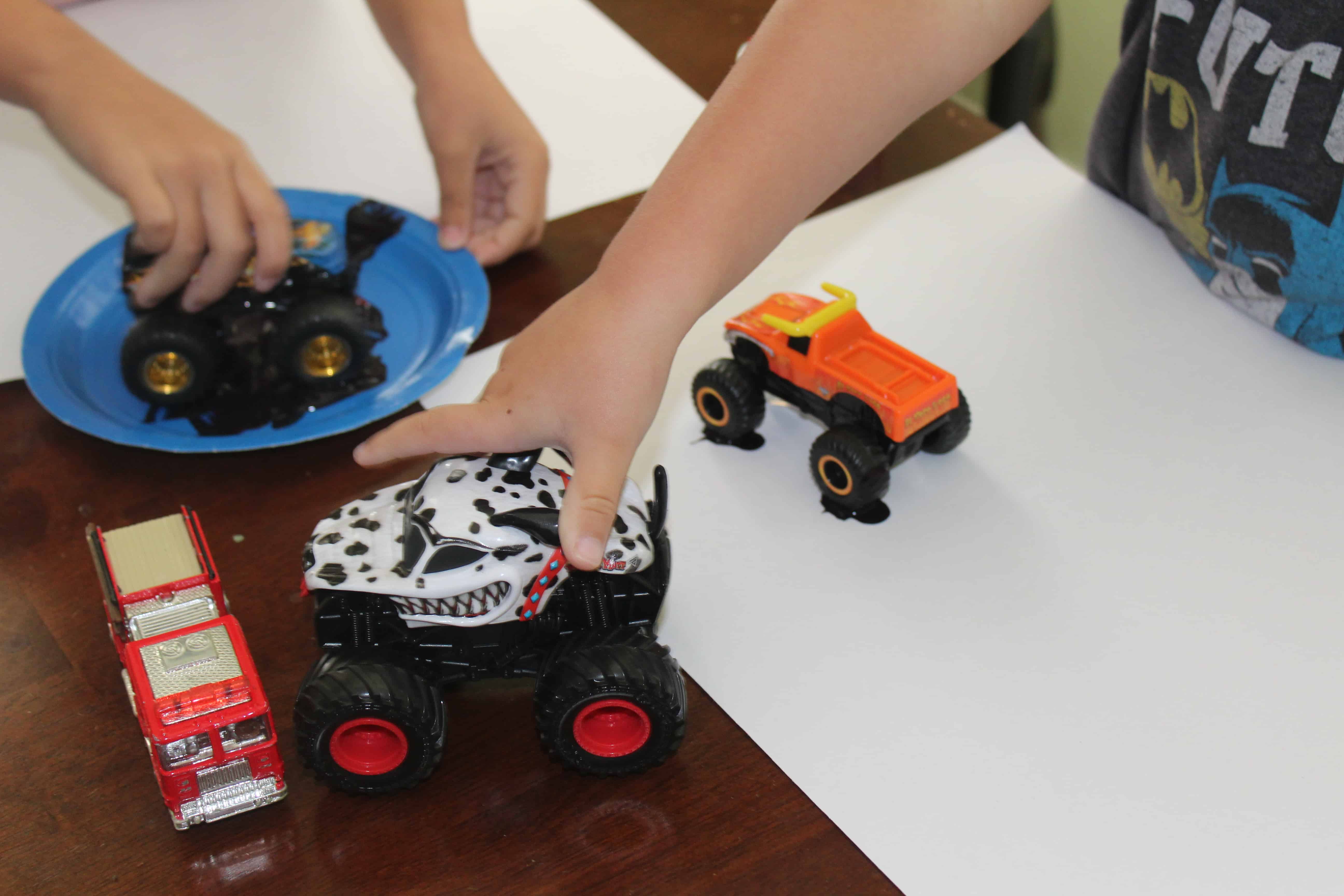 Toy trucks and a plate of "mud" with activity mats