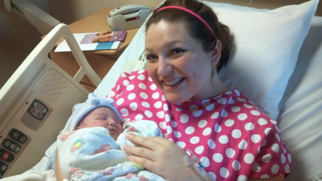 mom with newborn in pretty hospital gown