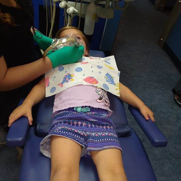 toddler getting her teeth cleaned