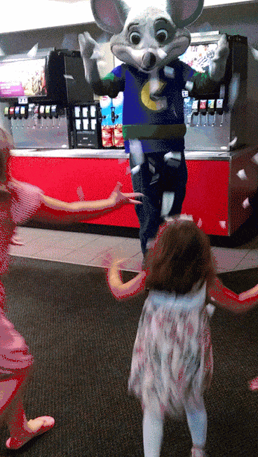 Chuck E cheese playing with toddlers giving tickets