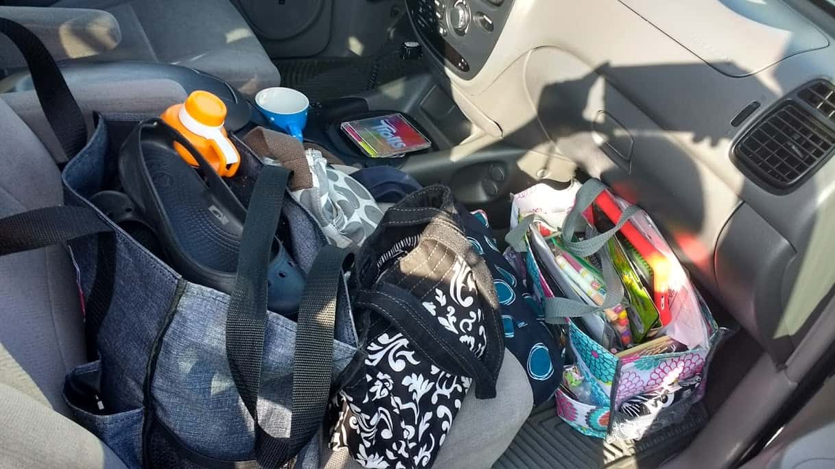 Passenger front seat of a car full of bags 