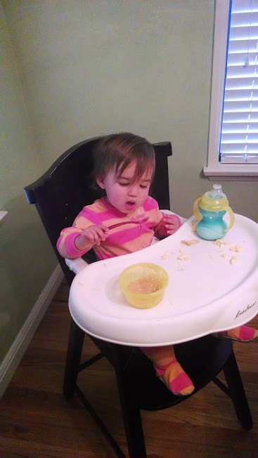 one year old eating applesauce