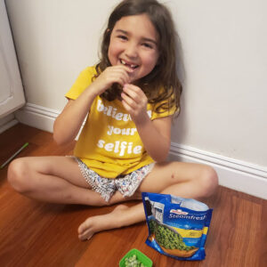 preschooler eating peas