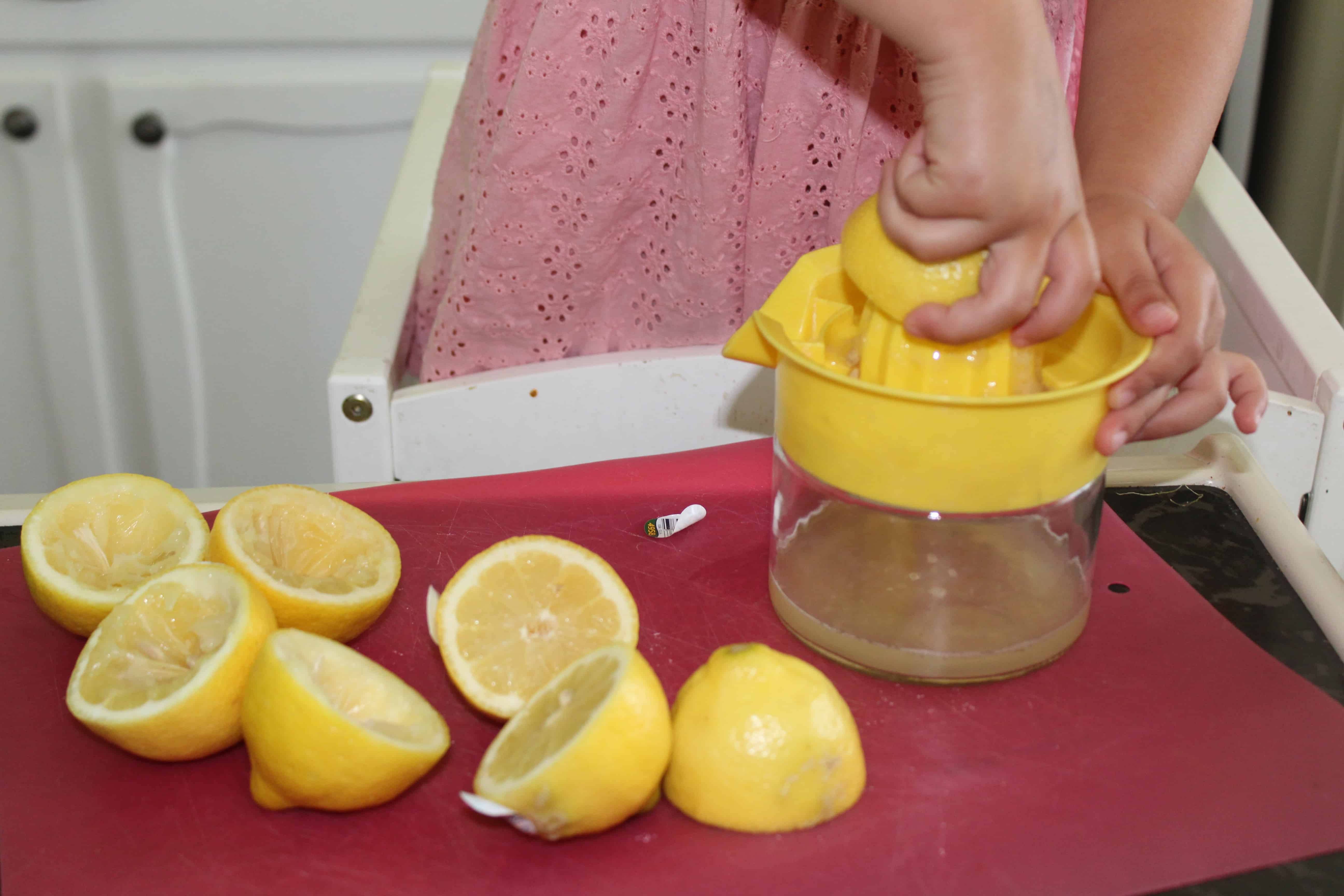 child juicing lemons