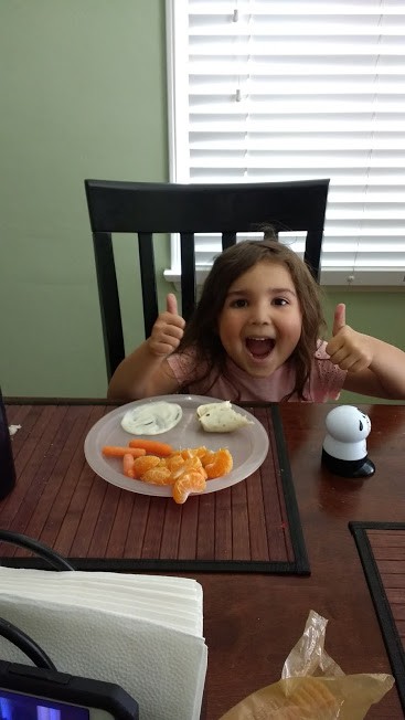 toddler giving fruits and veggies a thumbs up