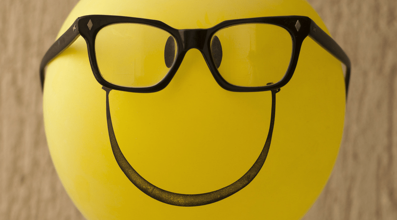 Smiley face inflatable yellow balloon with glasses