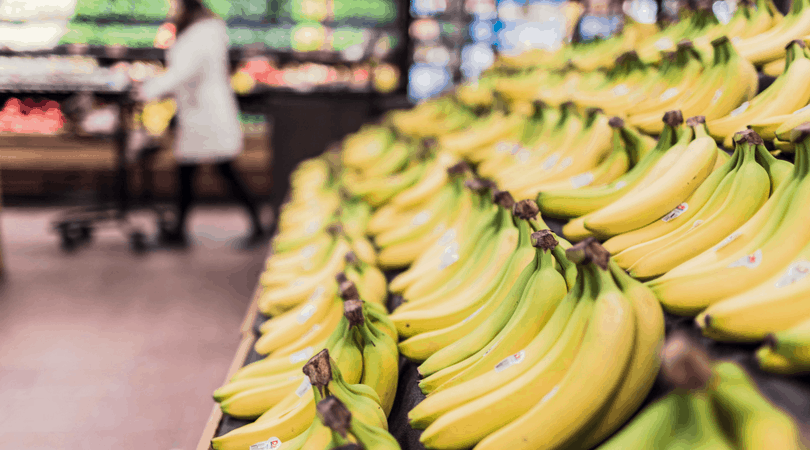 Banana's in the aisle of a grocery store