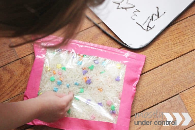 toddler using an ispy bag to practice colors