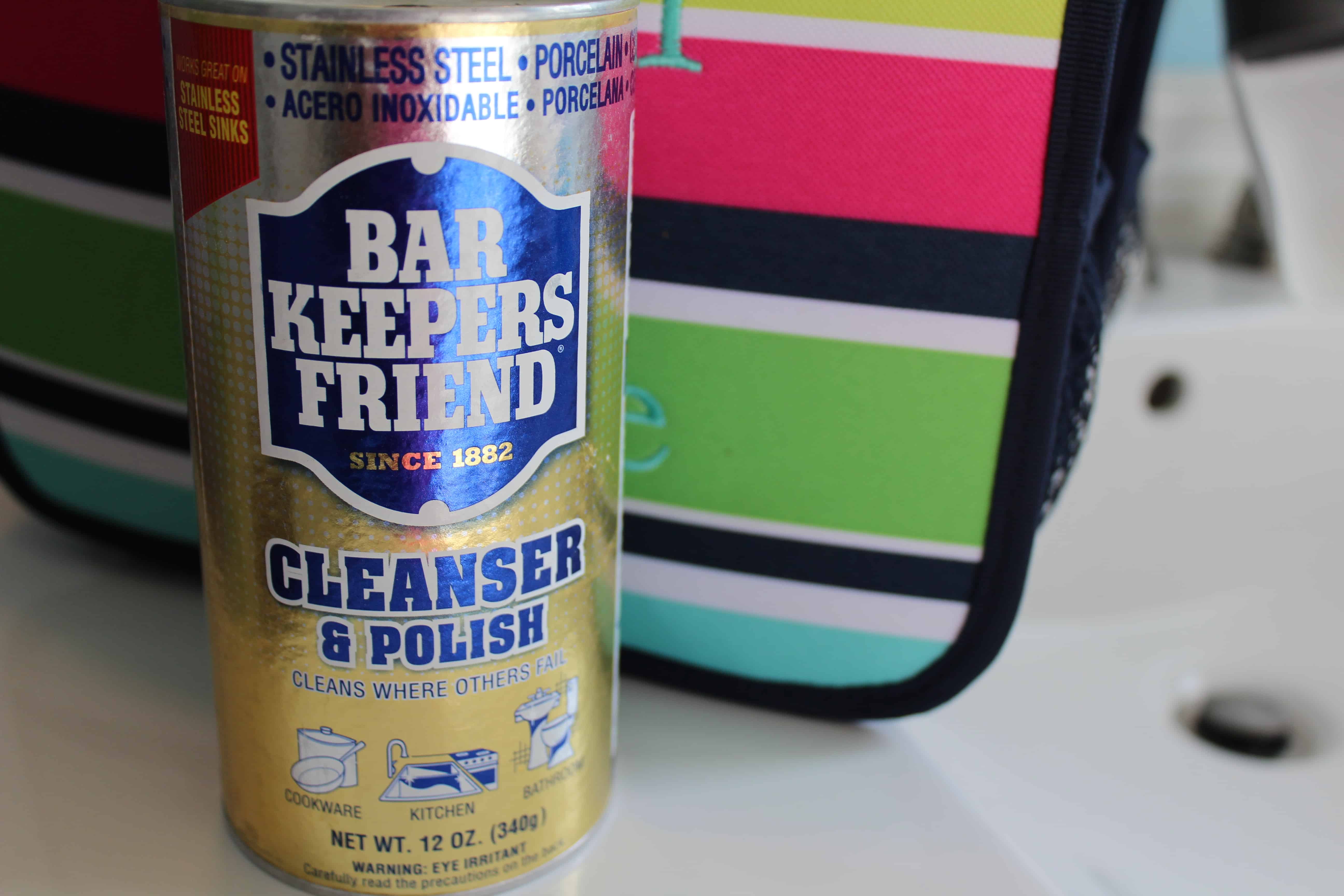 A can of barkeepers friend next to a caddy bag.