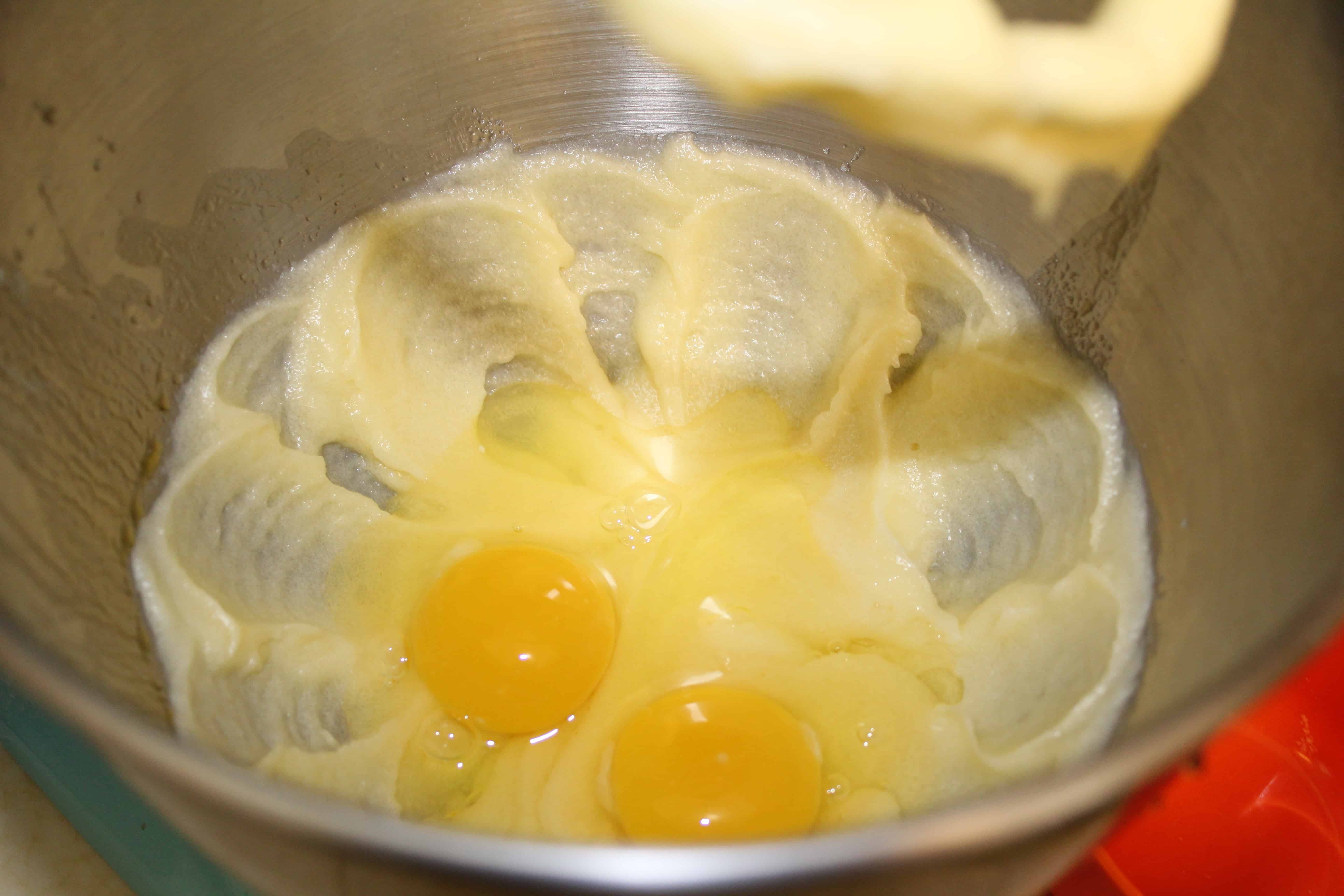 Eggs, butter and sugar in a mixing bowl.