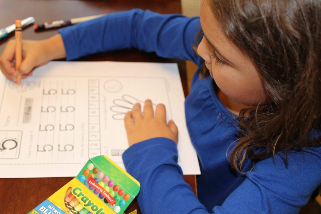 kindergartener doing a worksheet