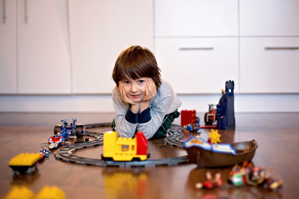 boy playing with toy train