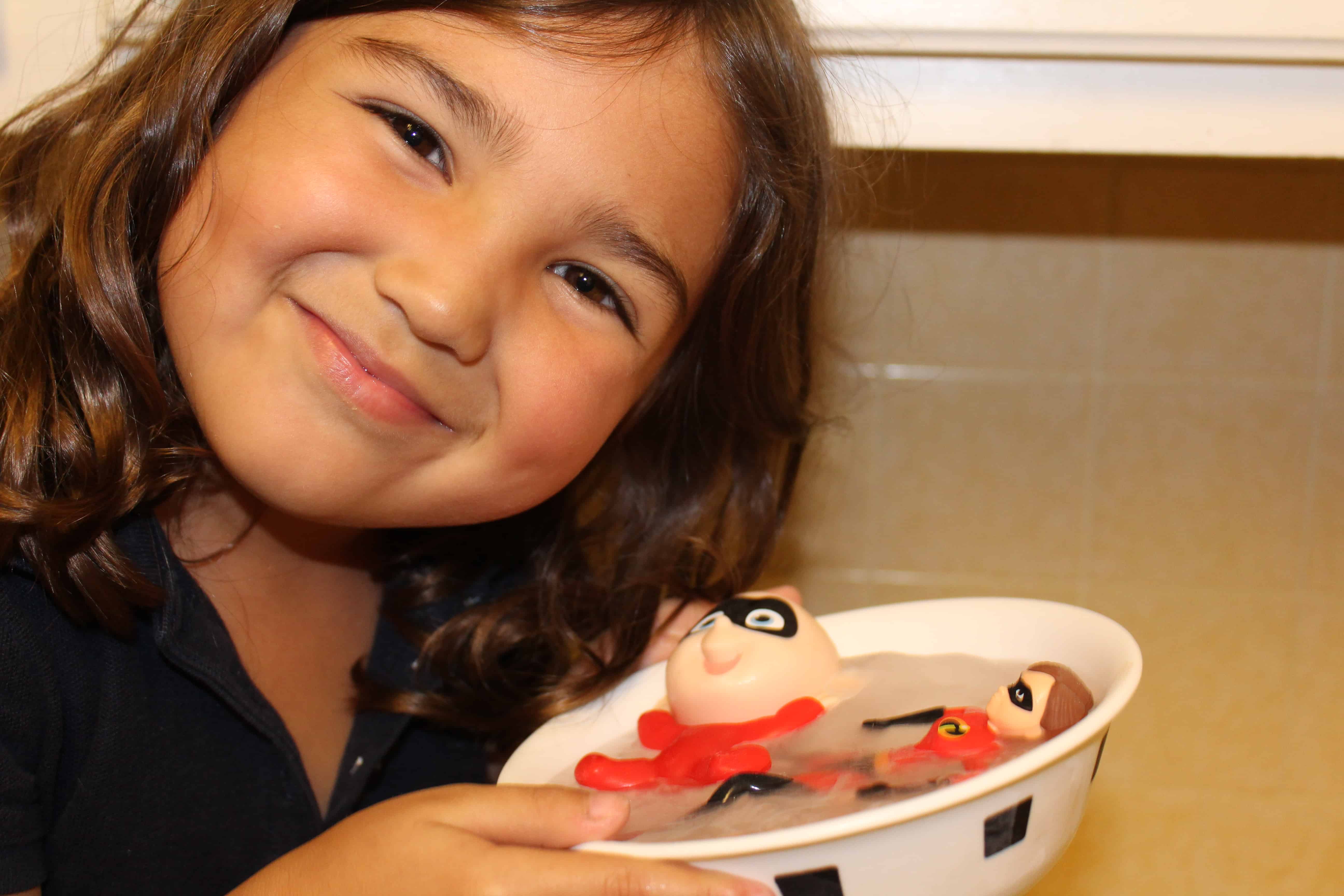 Smiling girl holding bowl of frozen ice.