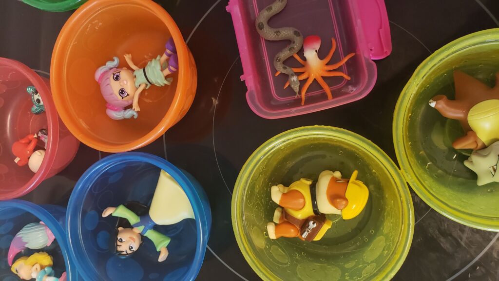 plastic toys arranged in bowls