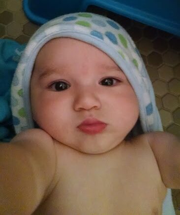 pouty baby in a bath towel