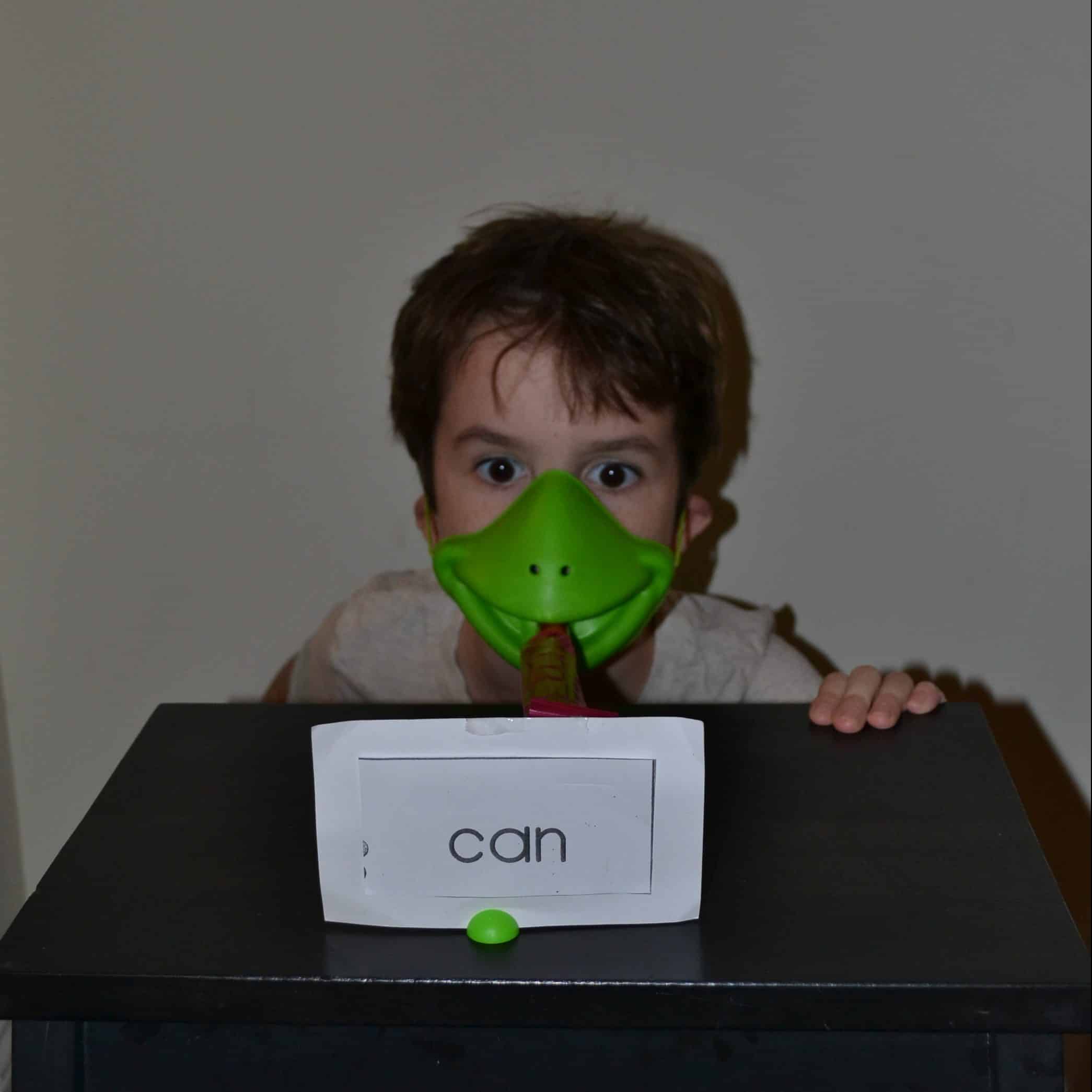 child wearing frog mask to practice sight words