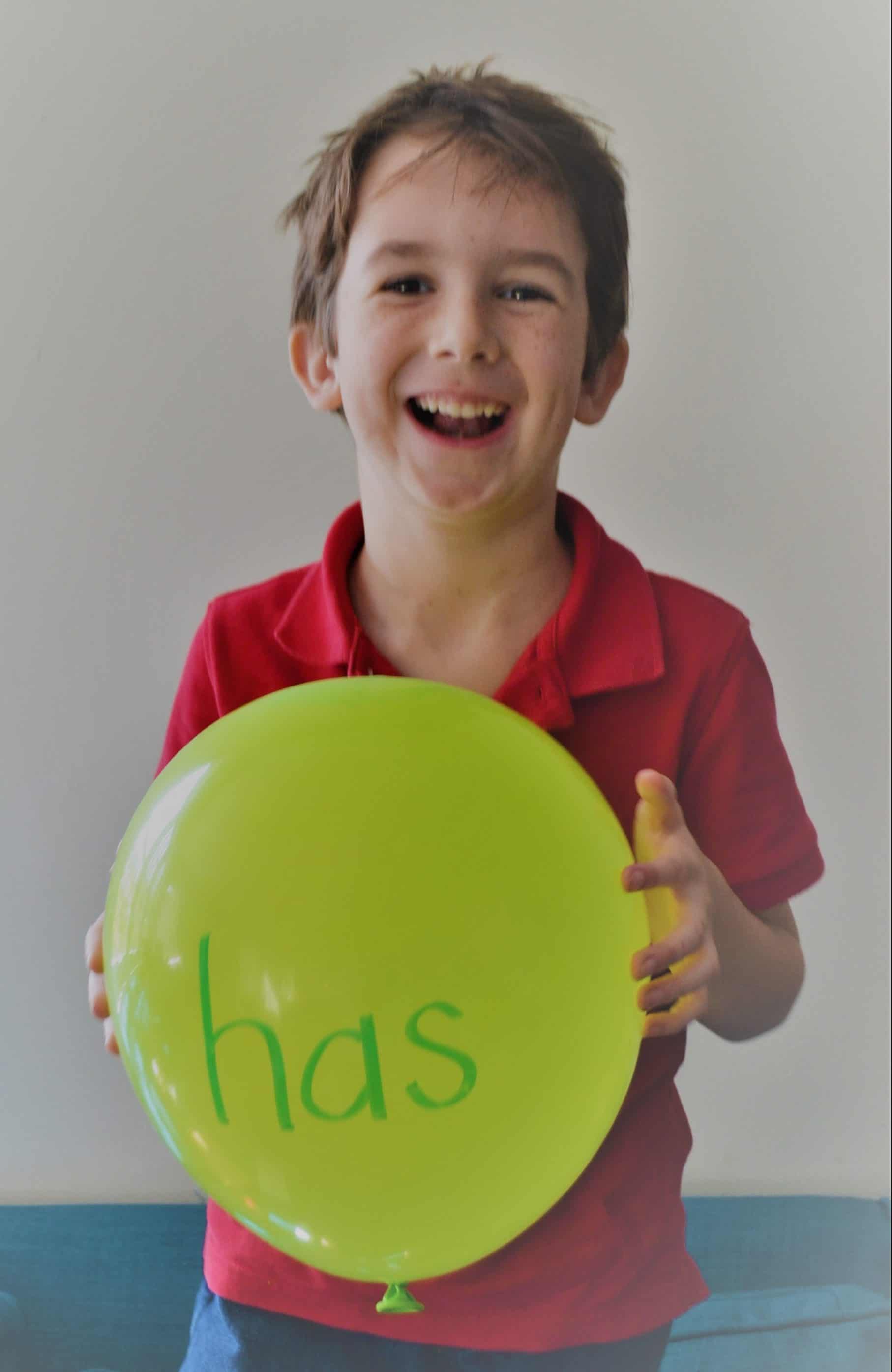 boy using balloons for sight word practice