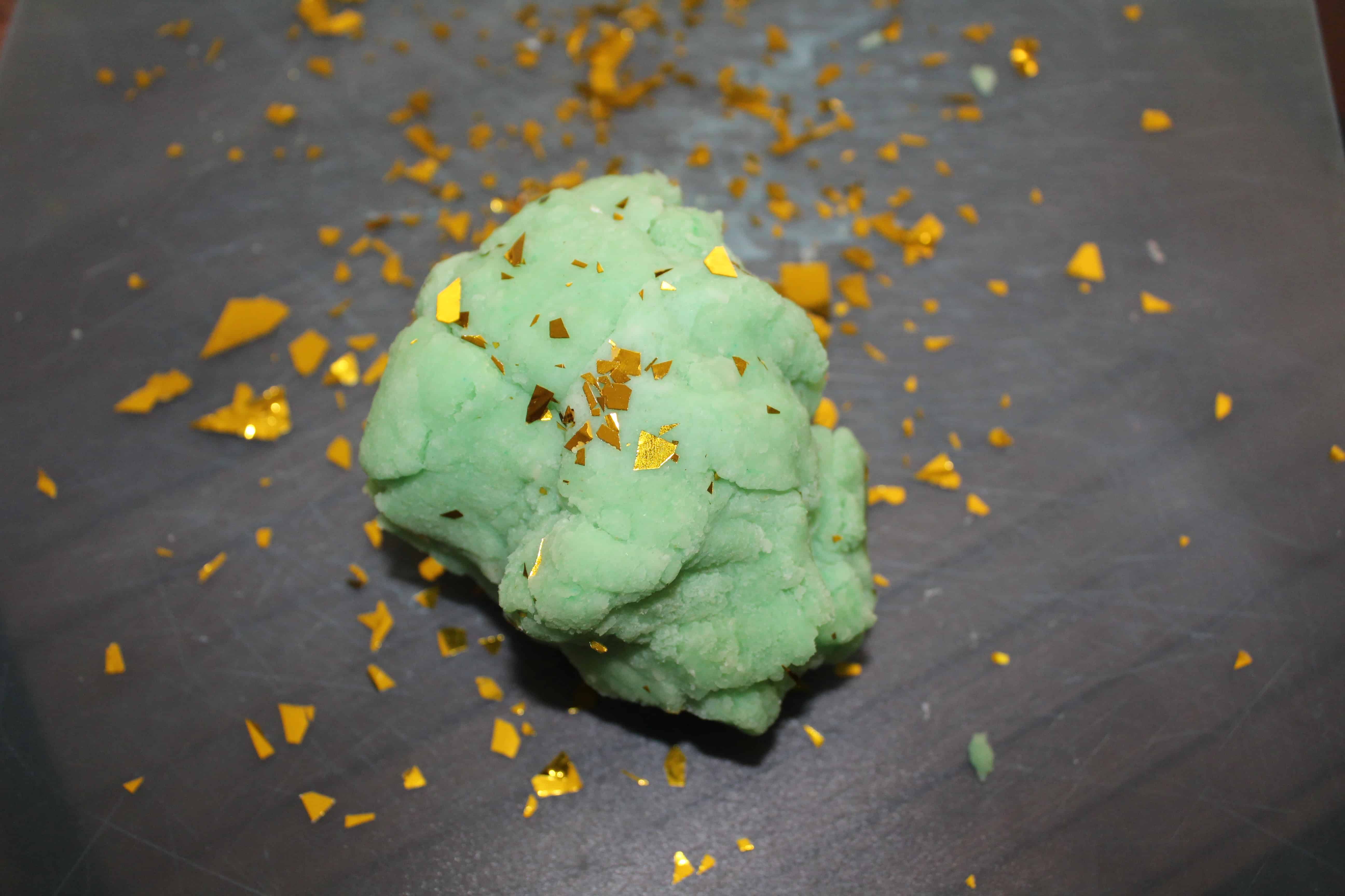 green playdough with gold flakes