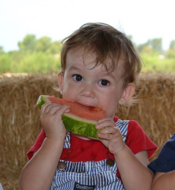 Toddler eating watermelon as a beach snack
