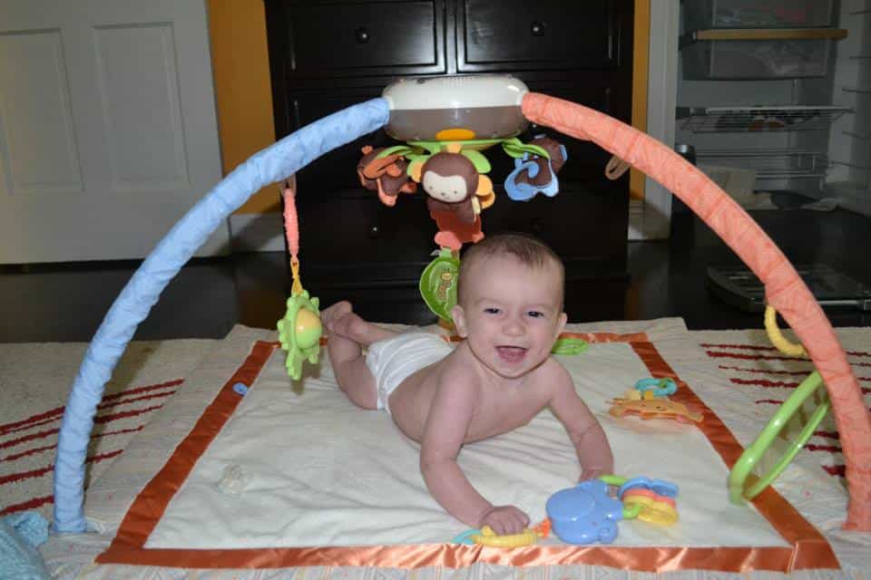 A Baby enjoying tummy time on a playmat