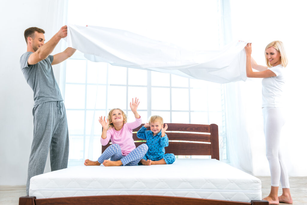 parents making the bed with kids