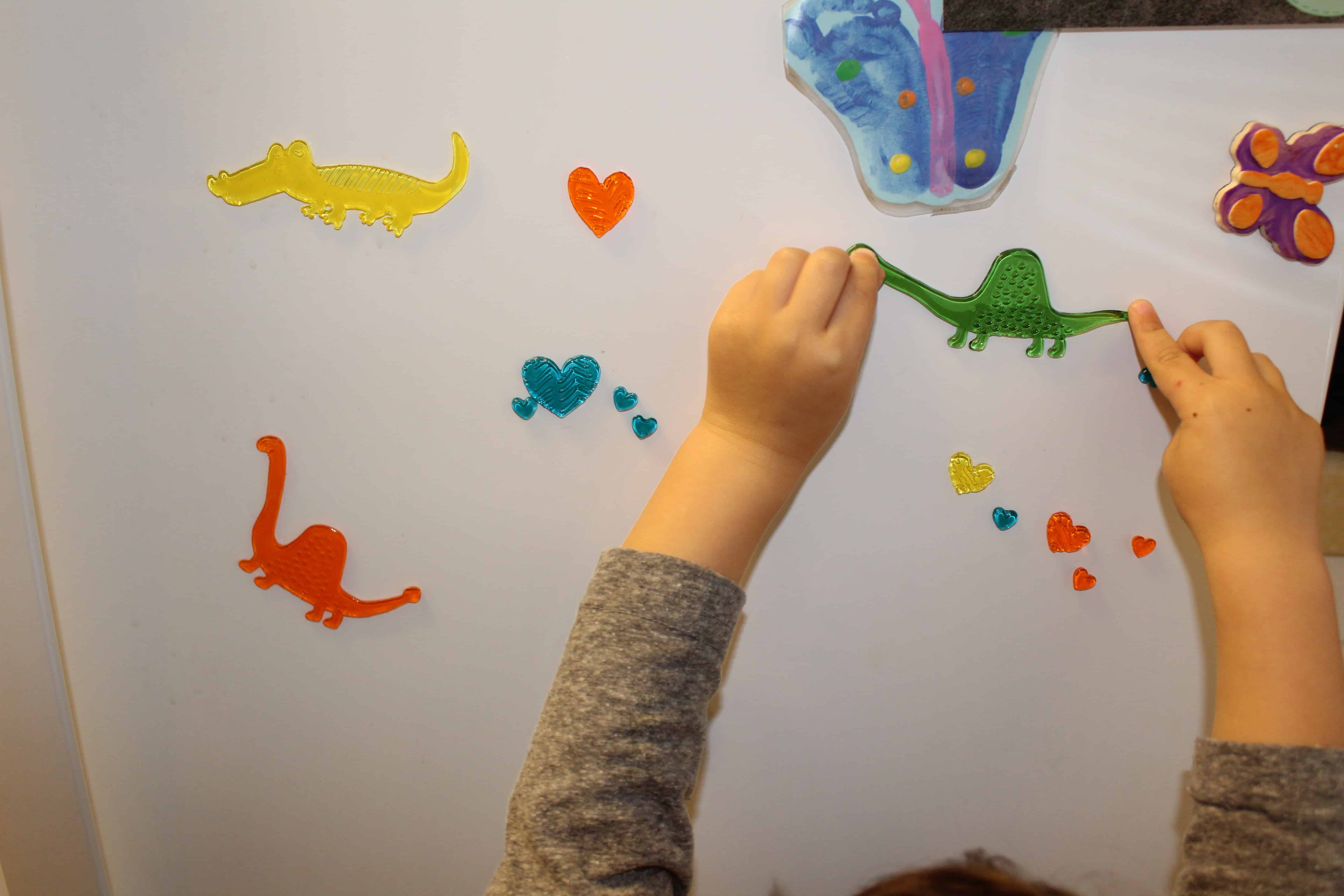 toddler playing with window clings- quiet activity for toddlers