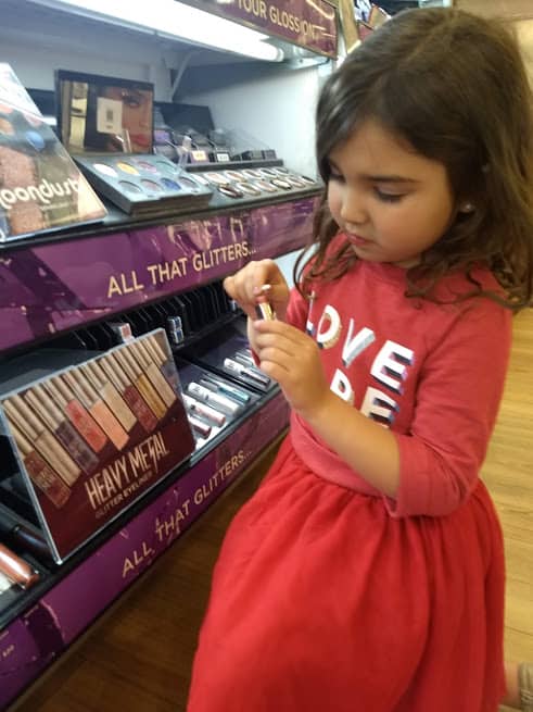 preschooler playing with makeup at ulta