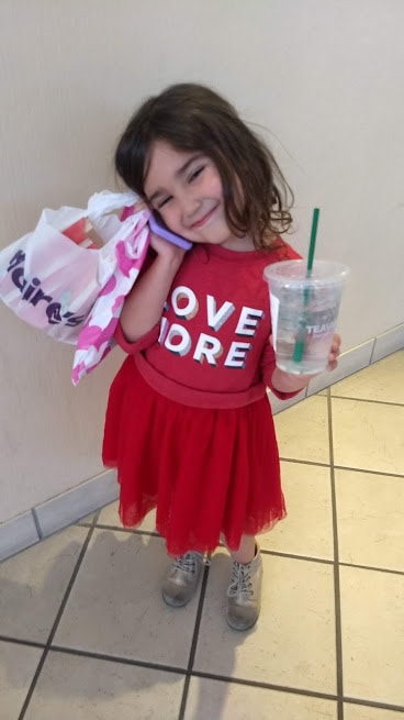 preschooler shopping, drinking from starbucks cup