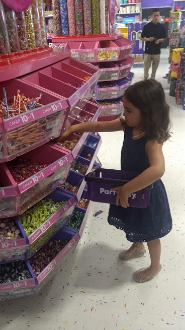 daughter shopping for candy at party city