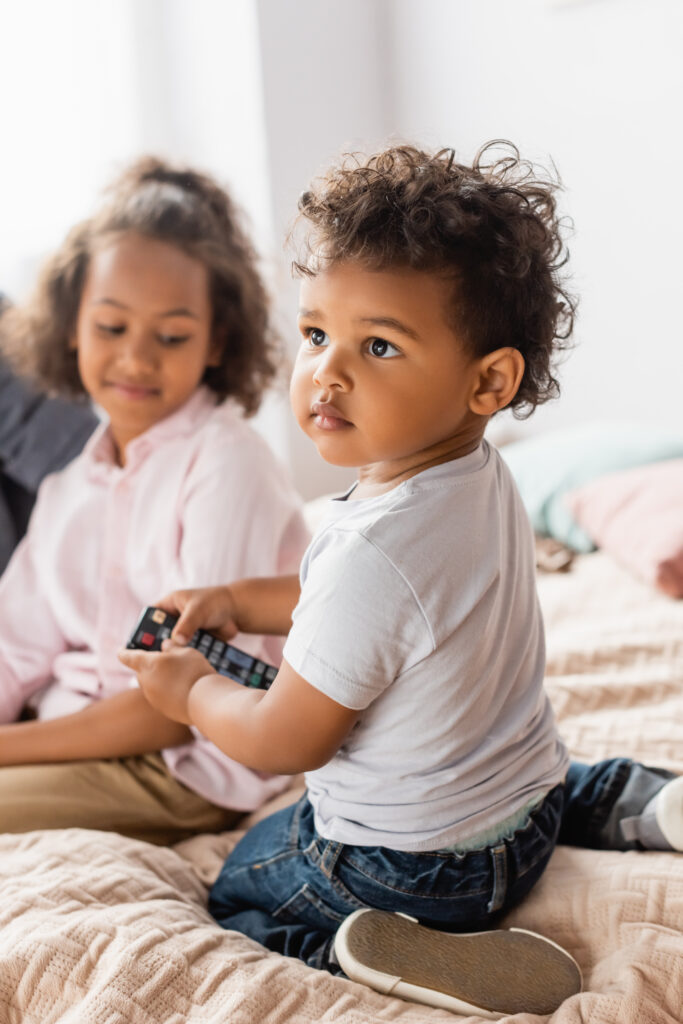 little boy holding remote control