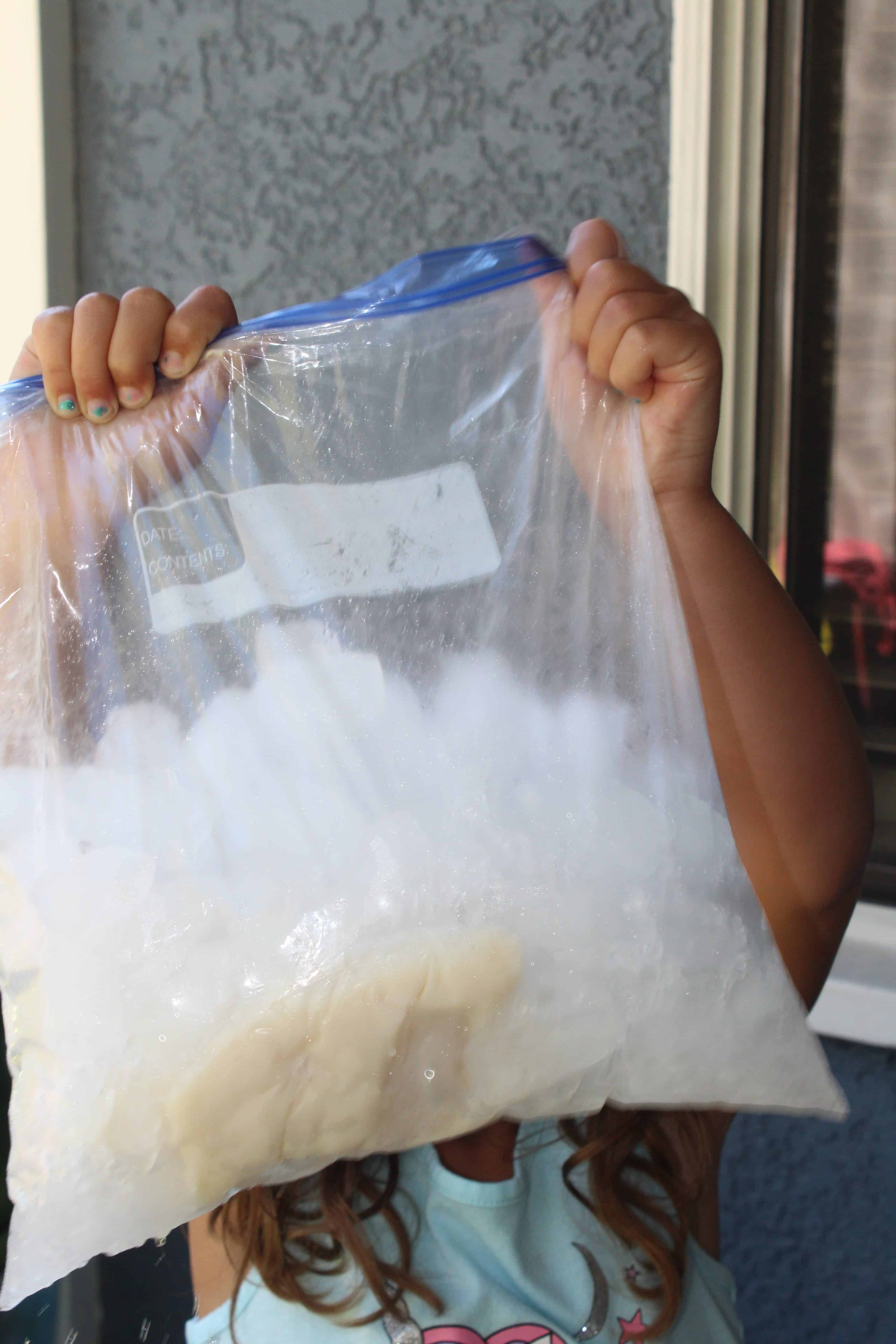 Child holding gallon back full of Ice and making ice cream