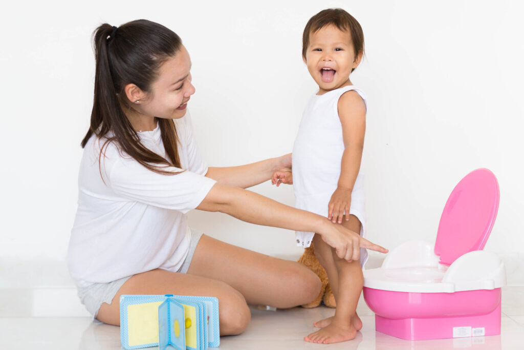 Mom points at potty after successful potty training