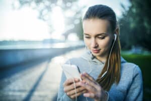 woman listening to meditation app using headphones