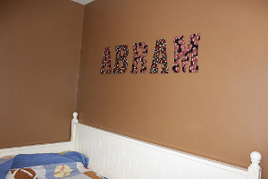 letters on a wall spelling out the name "abram"