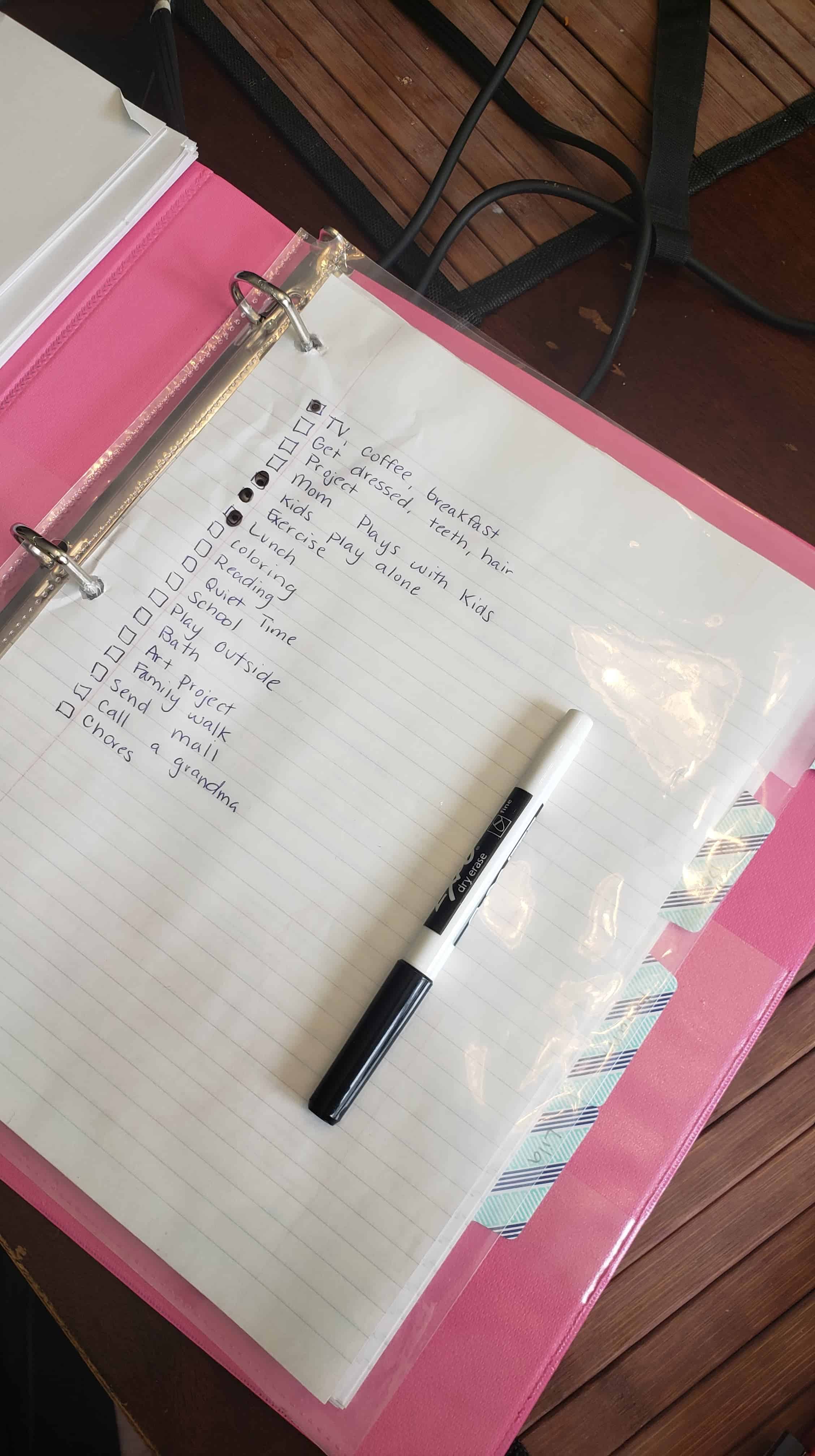 Pink Binder containing to do checklist.