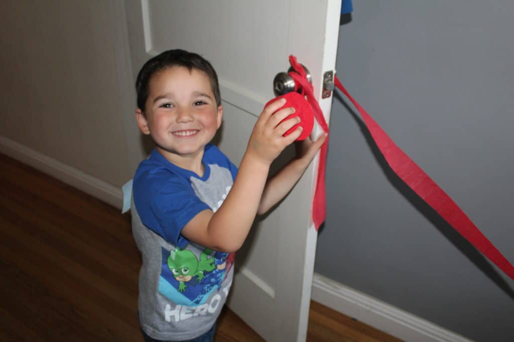 child decorating for read across america day with crepe paper