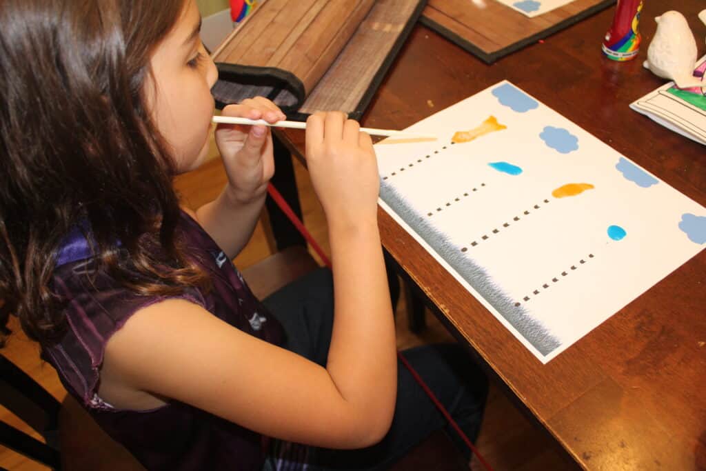 preschooler making truffula tree art with paint