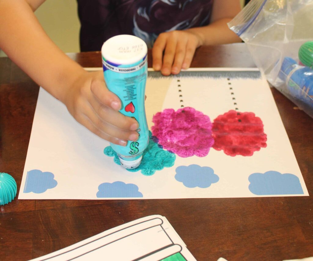 preschooler using do a dot markers to make truffula trees