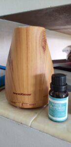 an essential oil diffuser and a bottle of white grapefruit essential oil