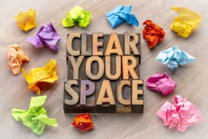 an image of type-blocks spelling "clear your space" with balled up, colorful paper around it.