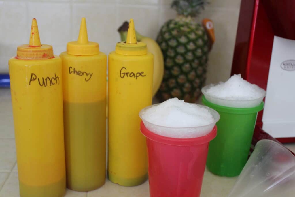 condiment bottles filled with homemade snow cone syrup