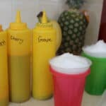 condiment bottles filled with homemade snow cone syrup