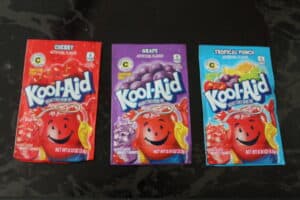 packets of cherry, grape, and tropical punch kool aid