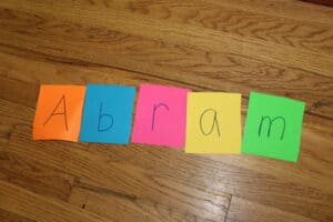 colorful index cards spelling out the word "abram," with one letter on each card