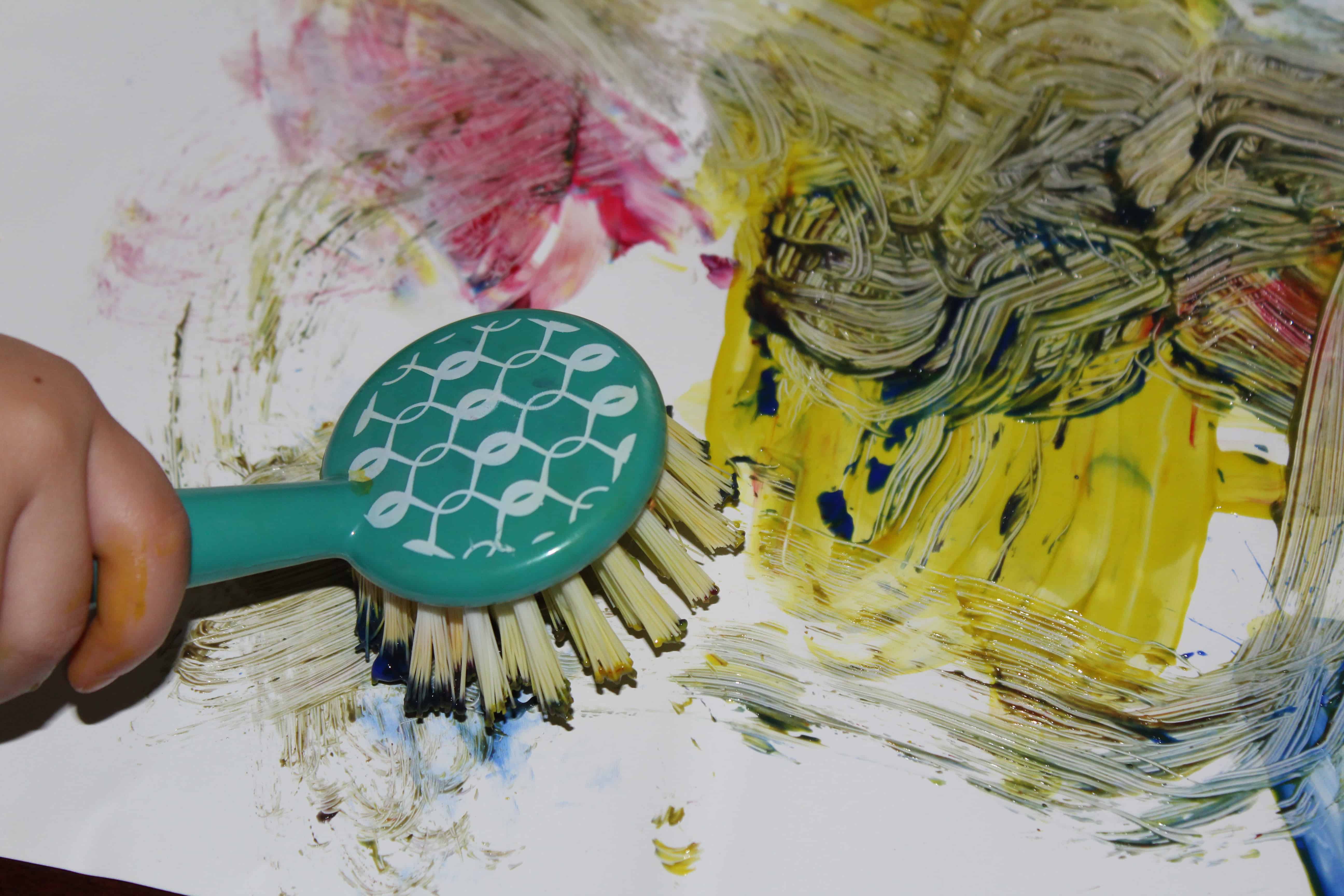 a messy painting by a preschooler, using a dish scrubber and paint